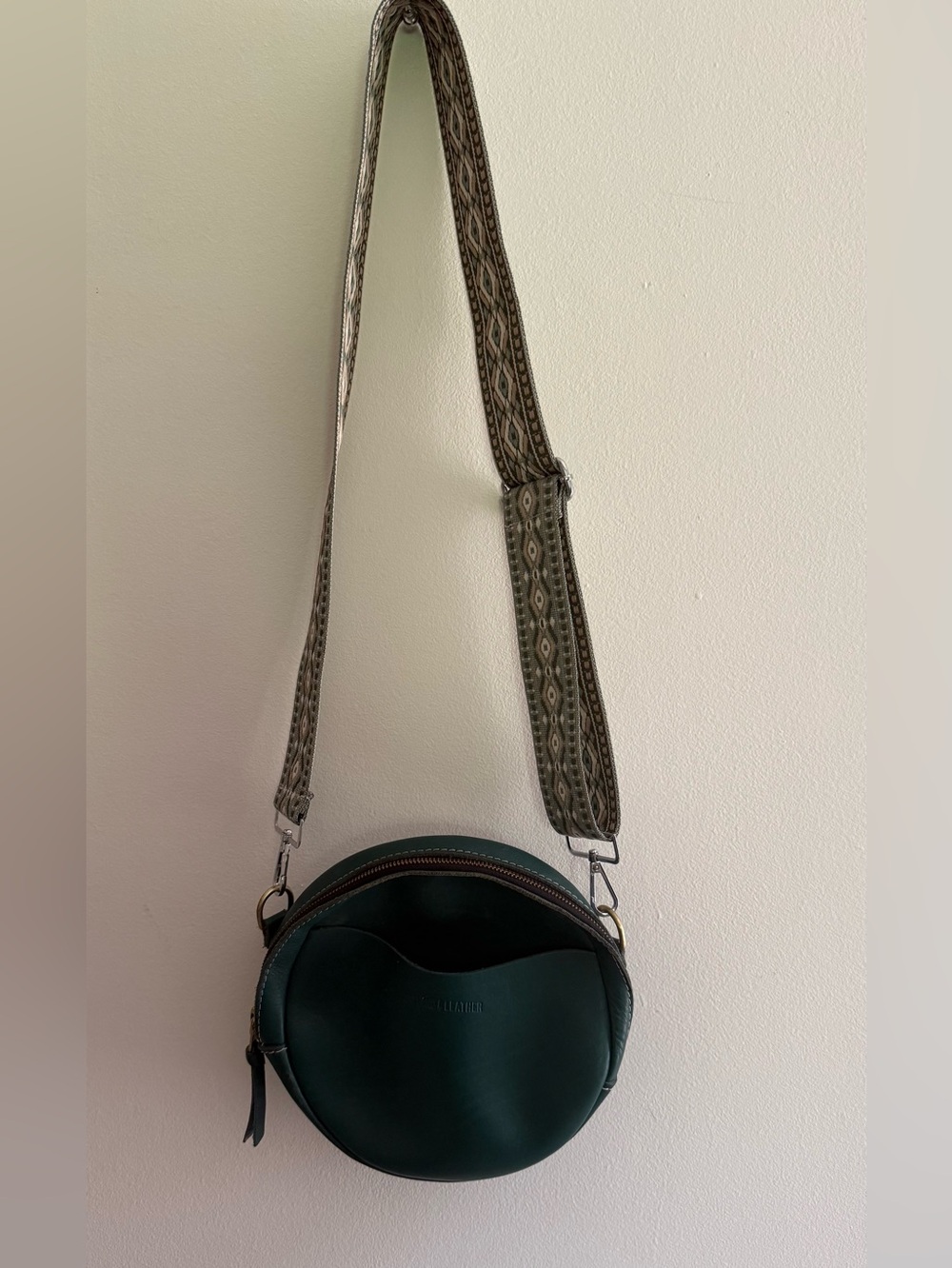 Portland Leather Dark Green Round Crossbody Bag with Patterned Strap
